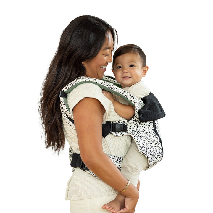 mom wearing baby in lillebaby complete all seasons baby carrier in salt and pepper