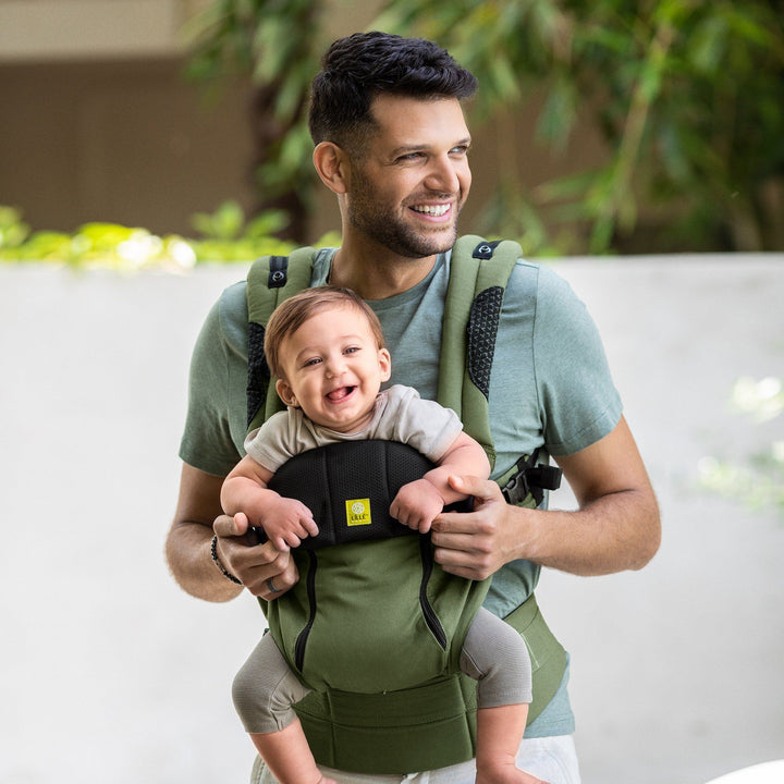 dad wearing baby in lillebaby complete all seasons baby carrier in succulent