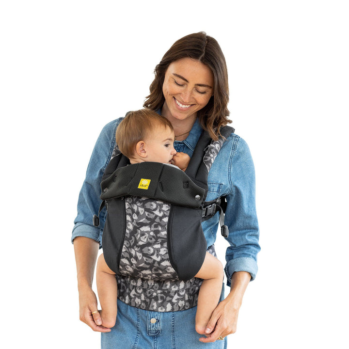mom wearing baby in lillbaby in complete all seasons baby carrier in twilight leopard