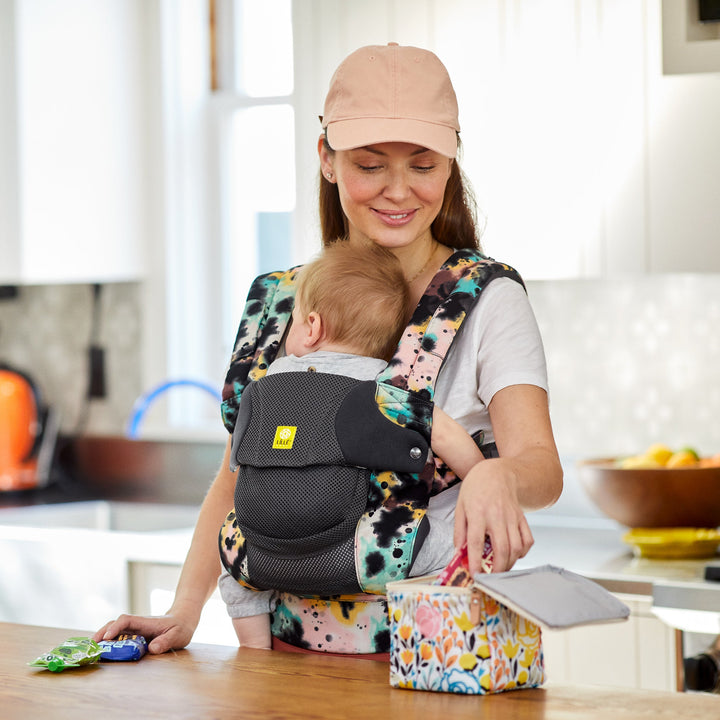 mom wearing baby in lillebaby complete airflow dlx baby carrier in watercolor space dye