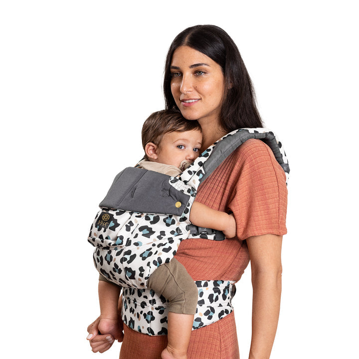 mom wearing baby in lillebaby complete luxe baby carrier in desert leopard