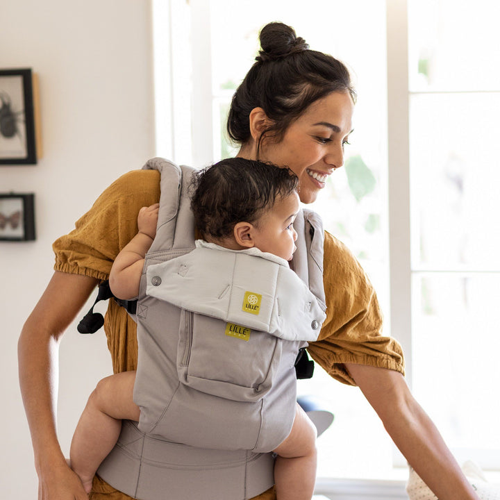 mom wearing baby in lillebaby complete original baby carrier in stone