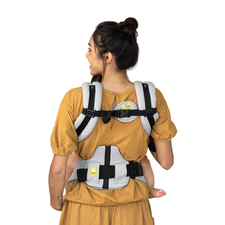 back image of mom wearing baby in lillebaby complete original baby carrier in stone