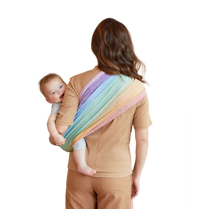 mom wearing baby in ring sling in rainbow back image